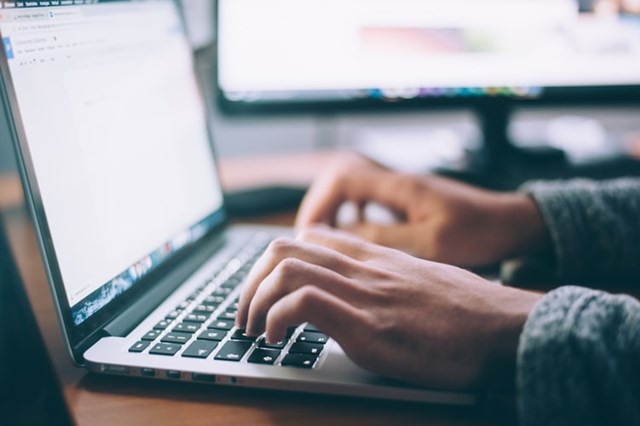 Someone Typing on Laptop Keyboard